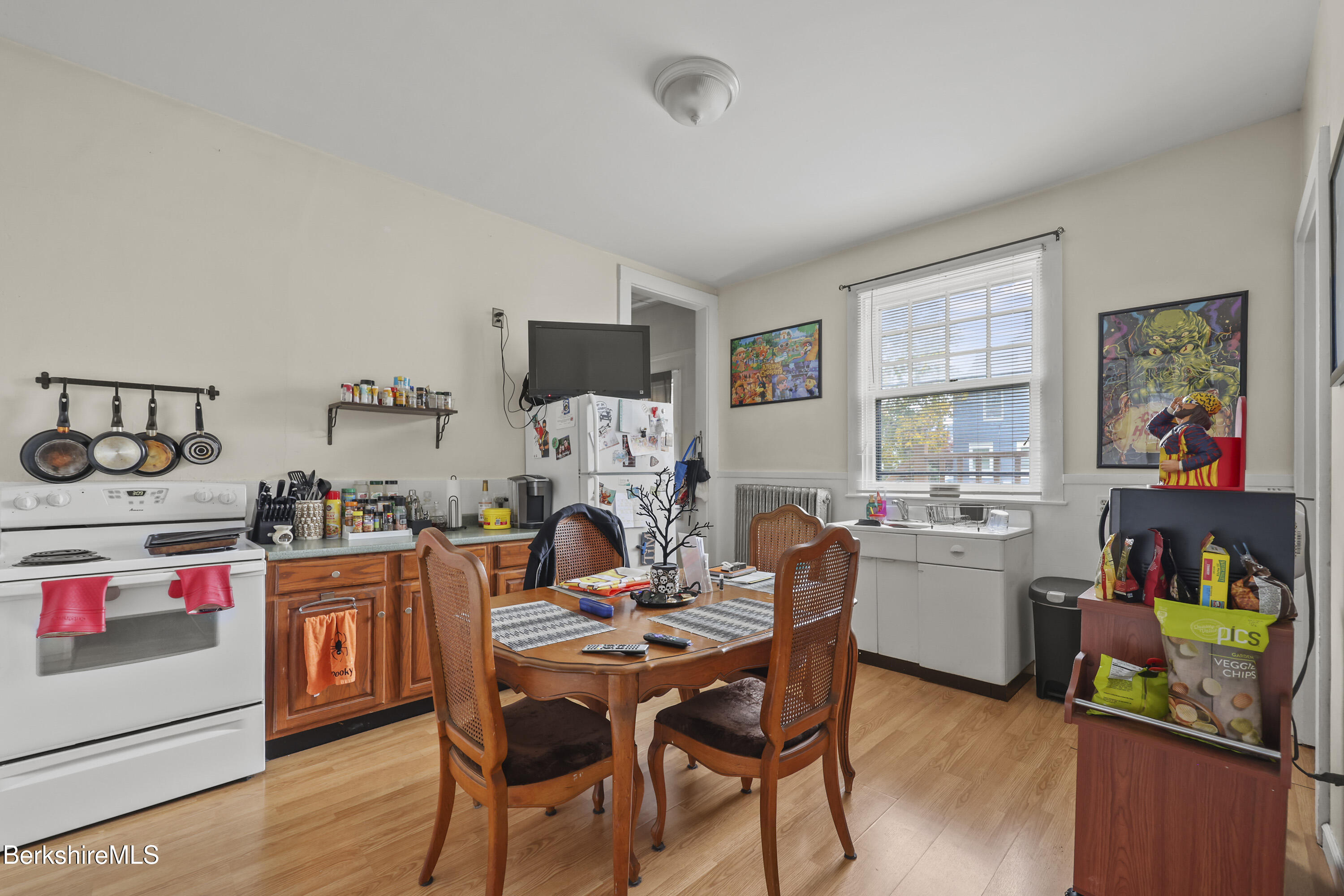 104 Appleton Avenue Pittsfield, MA 01201 - Photo 6 of 50 a kitchen with a dining table chairs and a refrigerator