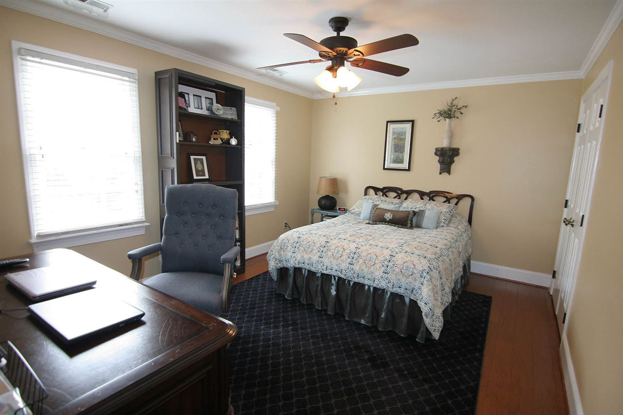 7903 Laurel Mountain Road Raleigh, NC 27613 - Photo 18 of 25 Secondary Bedroom has Hardwood Floors, Ceiling Fan, Crown Molding and Double Closet Bedroom