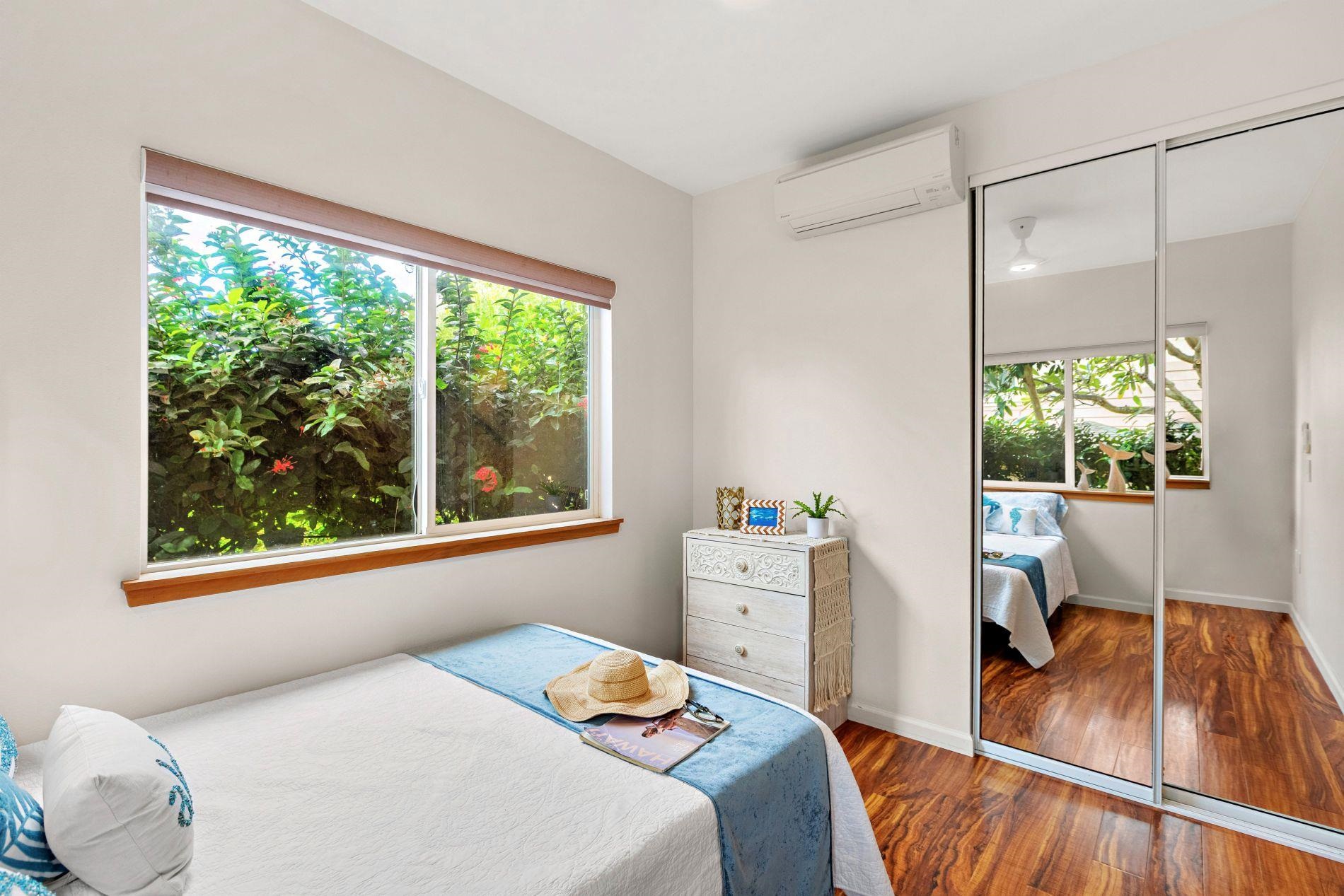 127 Punohu Lane, Unit 72 Lahaina, HI 96761 - Photo 19 of 43 a bedroom with a bed and a large window
