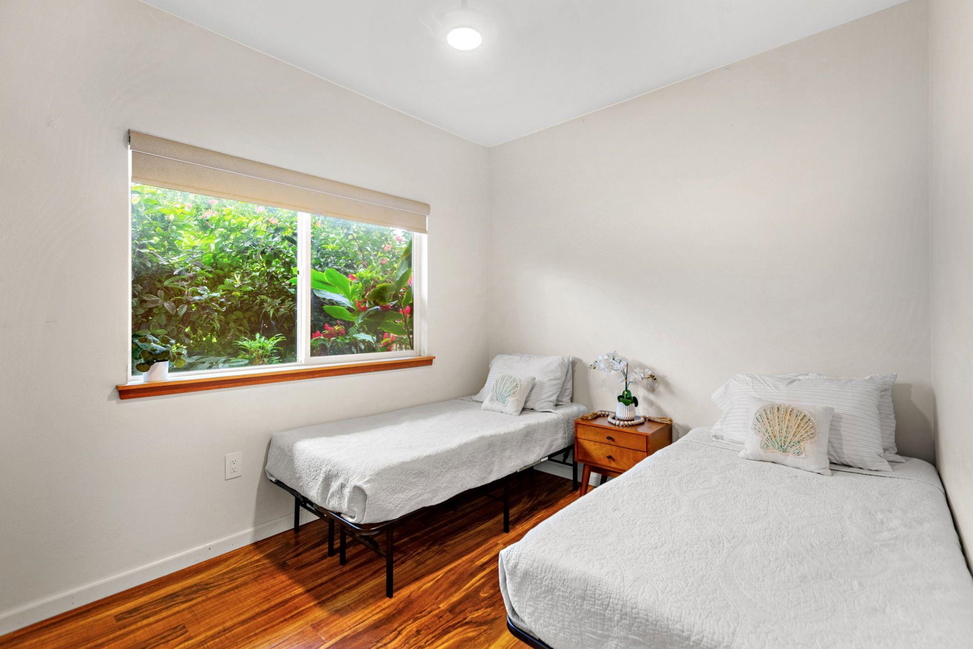 127 Punohu Lane, Unit 72 Lahaina, HI 96761 - Photo 23 of 43 a bedroom with two beds and a window