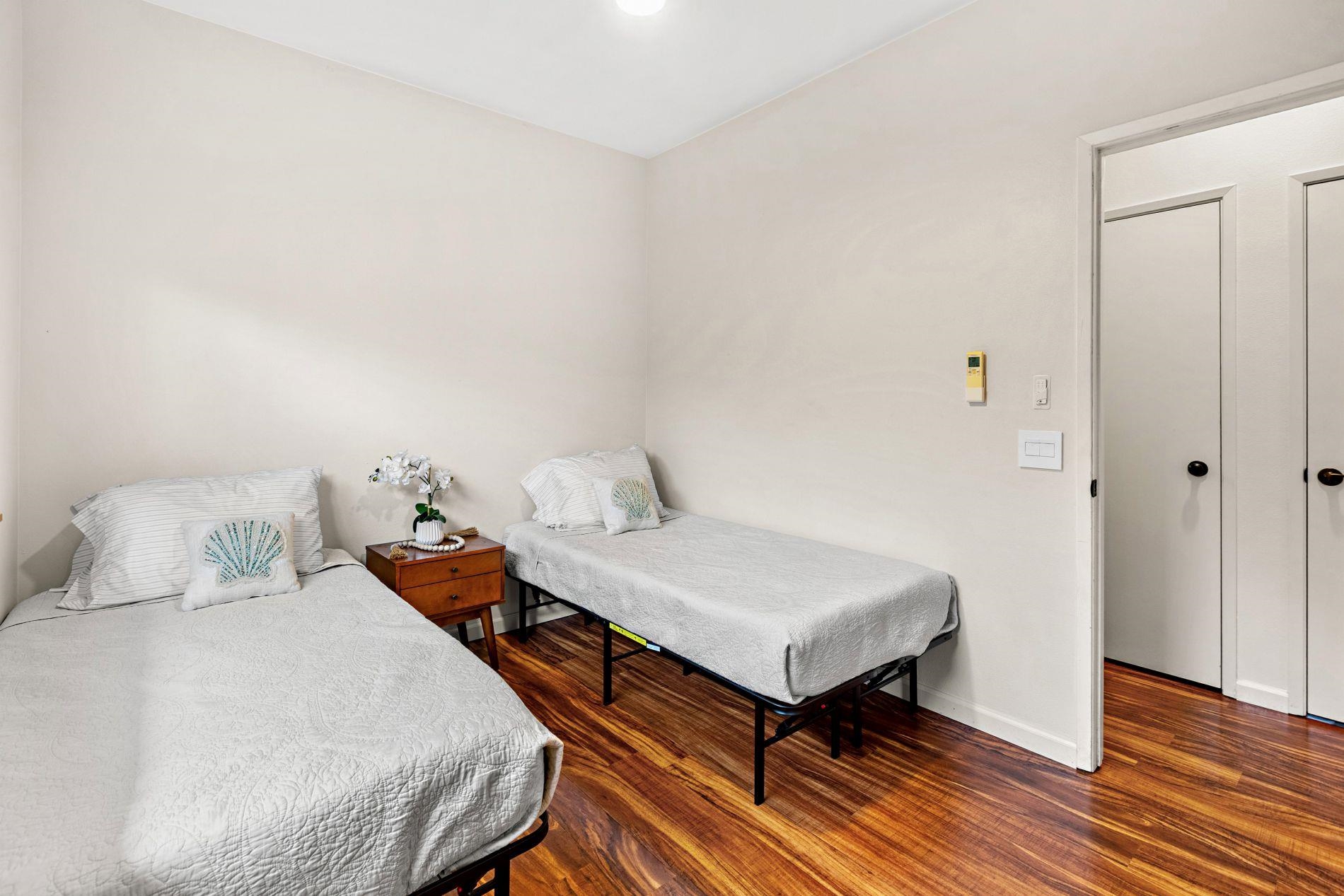 127 Punohu Lane, Unit 72 Lahaina, HI 96761 - Photo 24 of 43 a bedroom with a bed and wooden floor