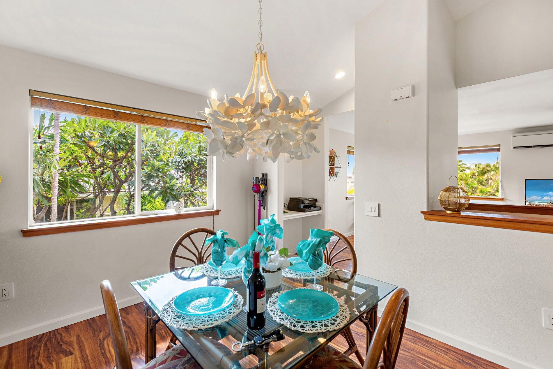 127 Punohu Lane, Unit 72 Lahaina, HI 96761 - Photo 34 of 43 a dining room with furniture a large window and a chandelier