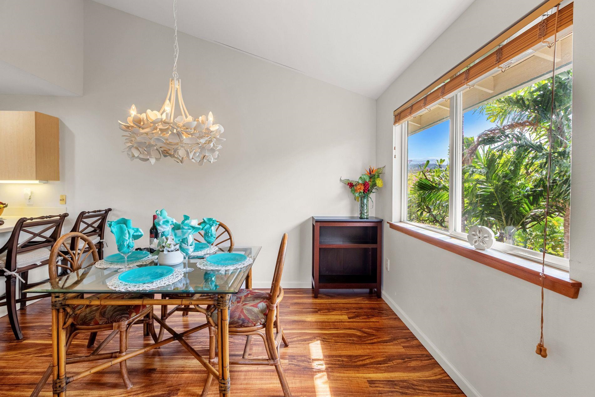 127 Punohu Lane, Unit 72 Lahaina, HI 96761 - Photo 35 of 43 a dining room with furniture a rug a potted plant and a chandelier