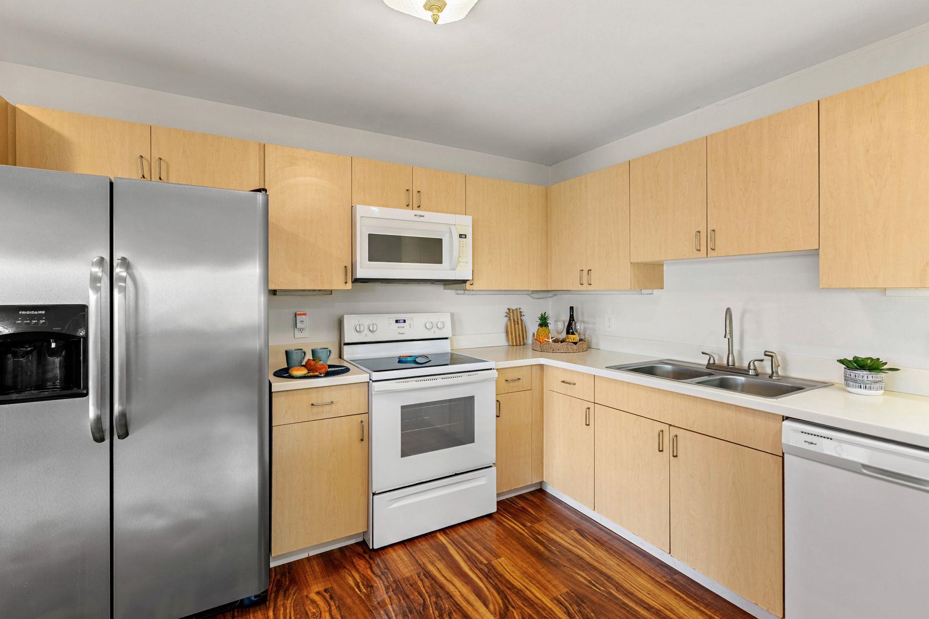 127 Punohu Lane, Unit 72 Lahaina, HI 96761 - Photo 7 of 43 a kitchen with a sink stove and refrigerator