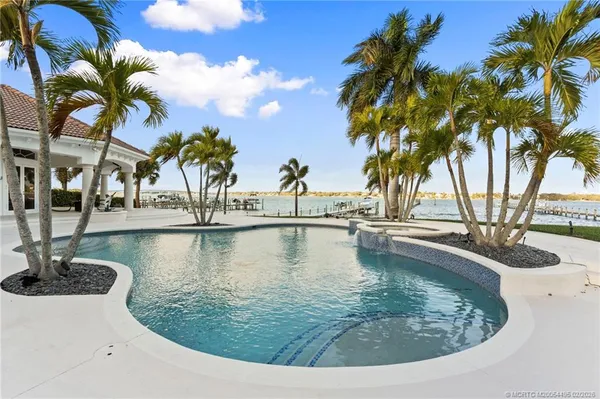 a view of a swimming pool with a table and chairs