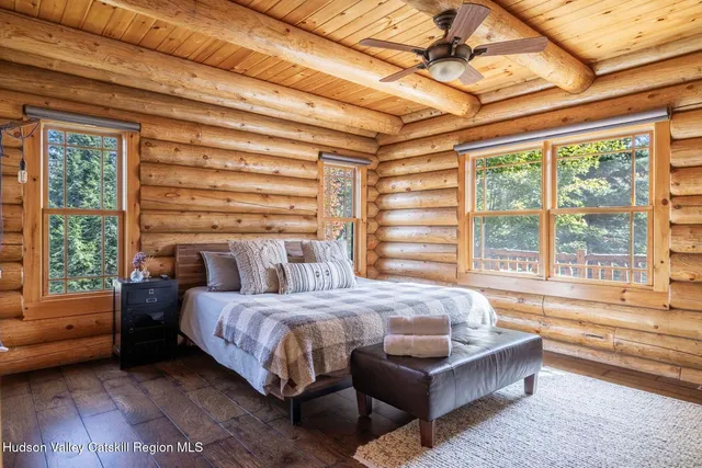 a bathroom with a bathtub and next to a window