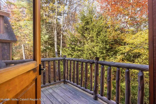 a view of staircase with lots of frames on wall and wooden floor