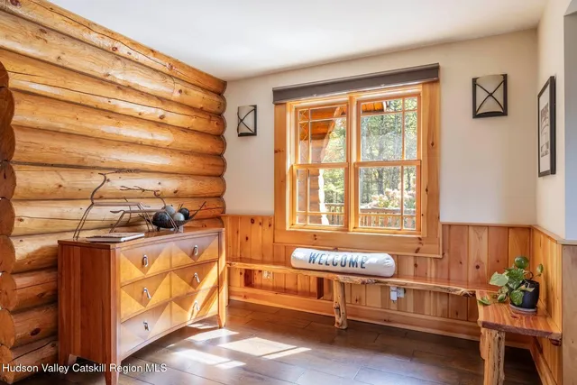 a bedroom with a bed and a large window