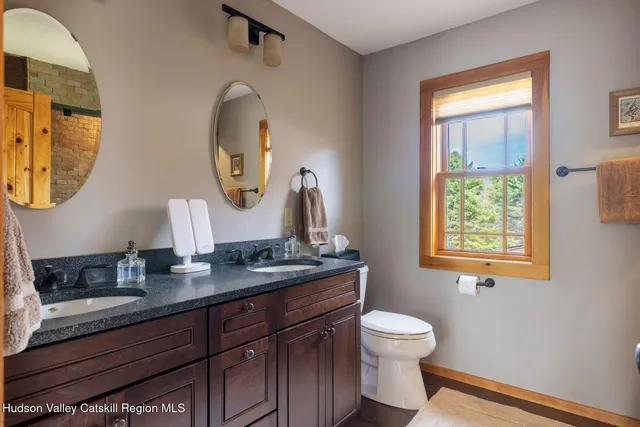 a front view of a house with a yard and trees