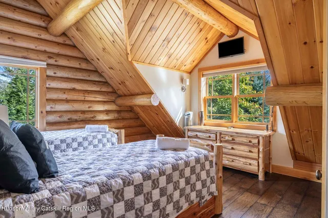 a aerial view of a house with table and chairs under an umbrella