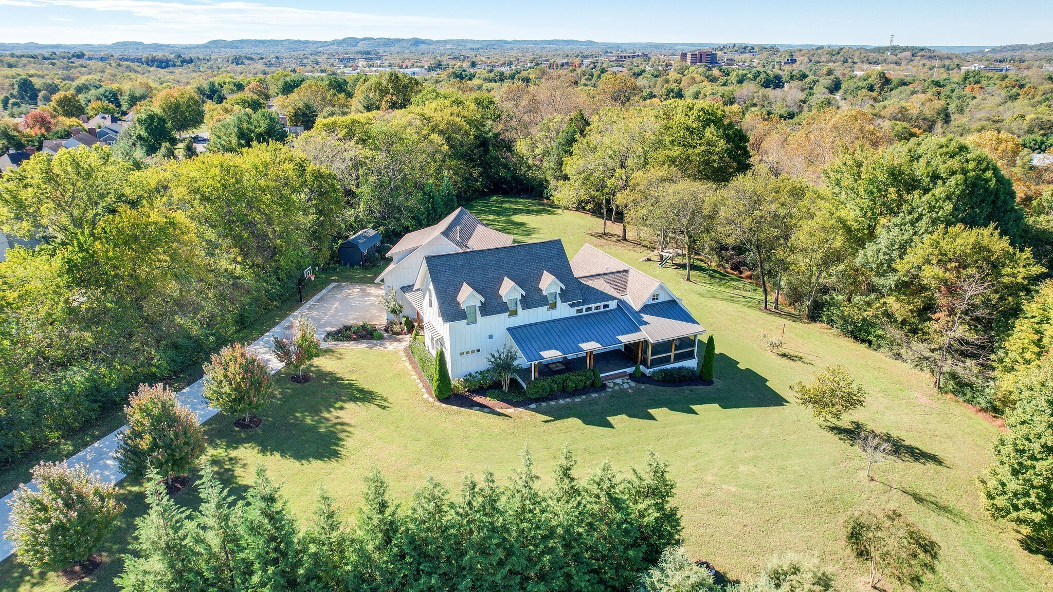 an aerial view of a house with a yard