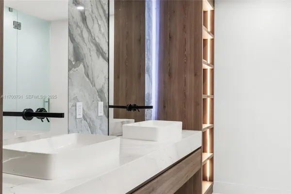 a spacious bathroom with a sink a toilet and a shower