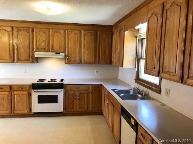 483 Shiloh Unity Road Lancaster, SC 29720 - Photo 15 of 22 a kitchen with stainless steel appliances granite countertop a sink a stove and a refrigerator