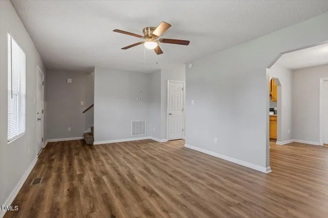 wooden floor in an empty room with a window