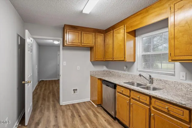 a kitchen with stainless steel appliances granite countertop a sink and cabinets