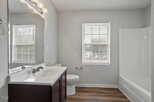 a bathroom with a sink toilet and tub
