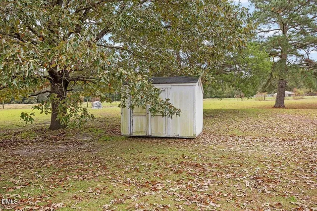 a view of a yard with large trees