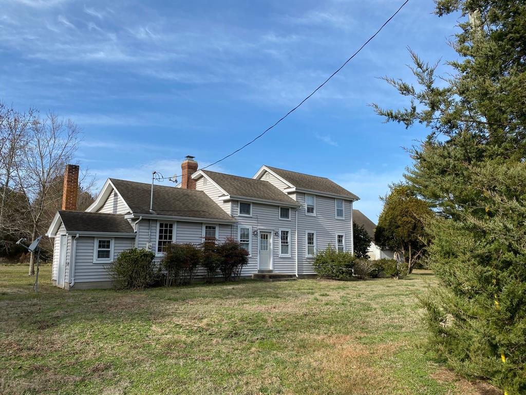 18222 Plantation Road Onancock, VA 23417 - Photo 1 of 1 a front view of a house with a garden
