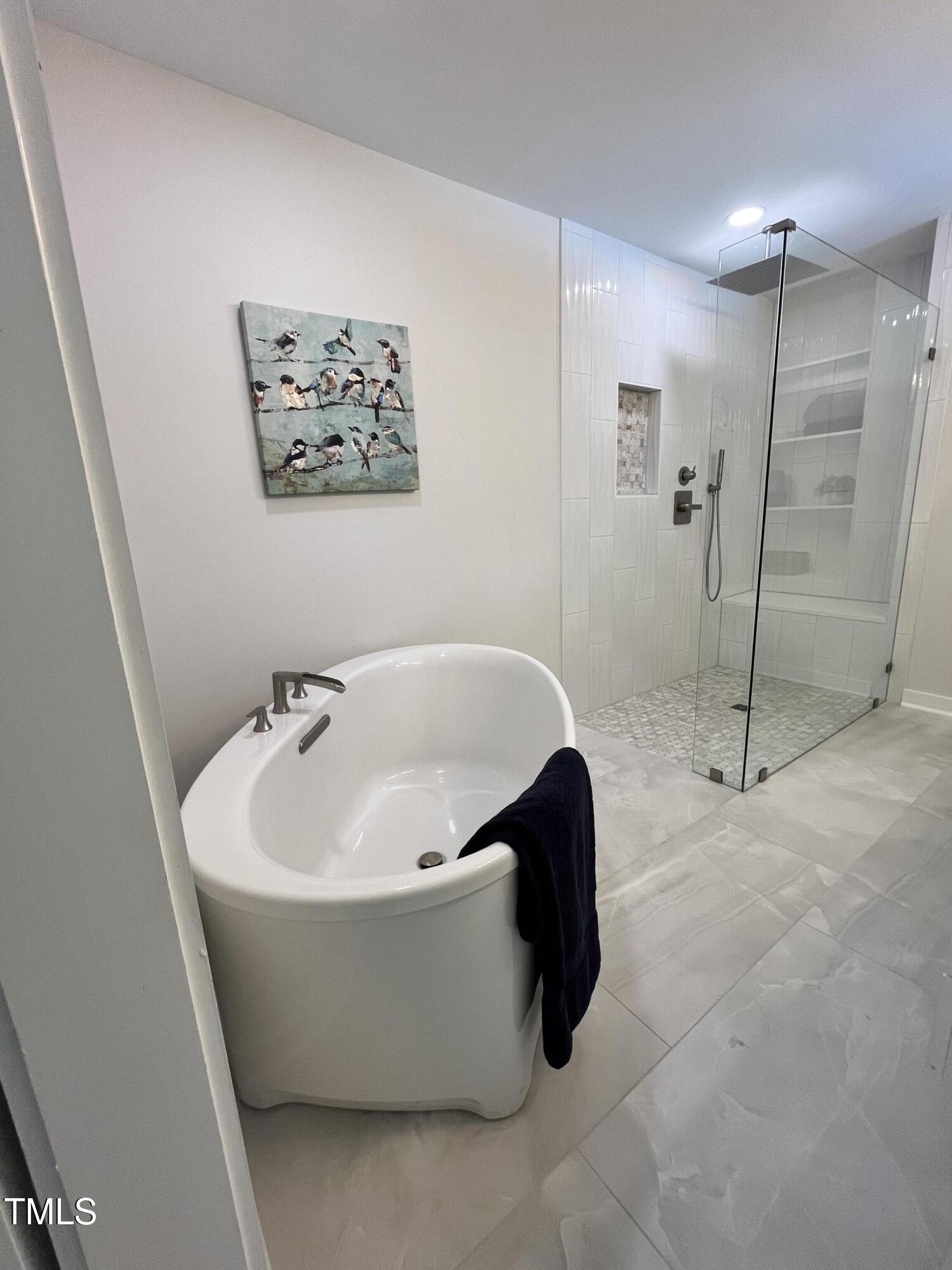 6801 Holly Springs Road Raleigh, NC 27606 - Photo 28 of 34 Soaking tub and zero entry master rainfall shower