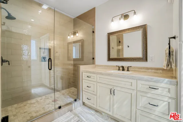 a bathroom with a double vanity sink and a mirror