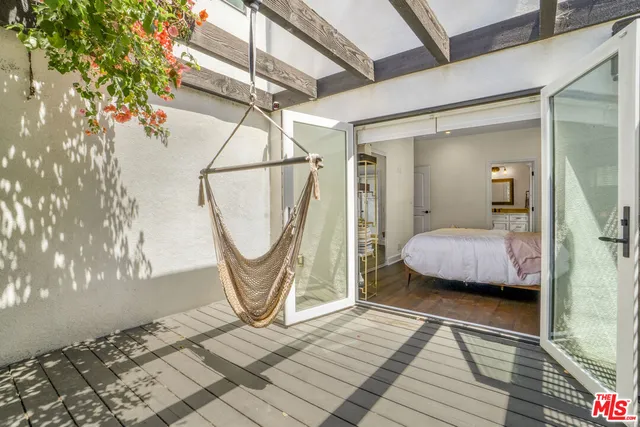 a living room with furniture a rug and a window