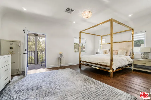 a spacious bathroom with a double vanity sink a mirror and a bathtub