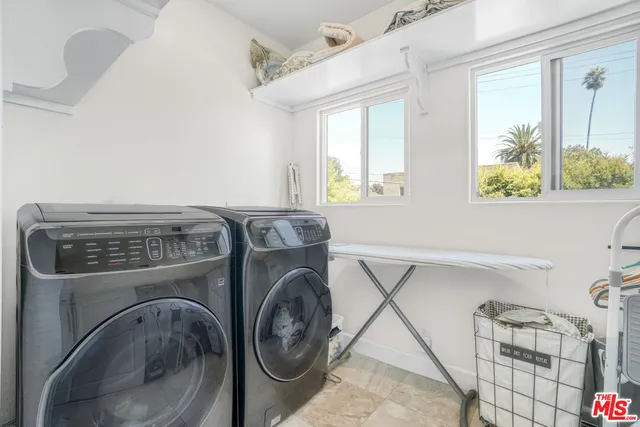 a bedroom with a bed and a potted plant