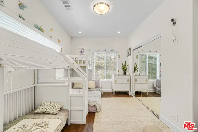 a view of a porch with couches and potted plants