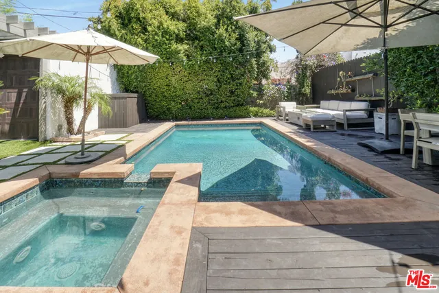 a swimming pool view with a outdoor seating