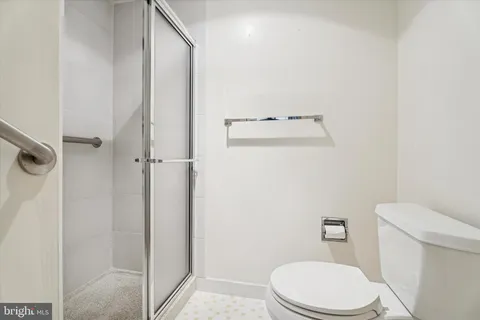 a white toilet sitting next to a bathroom sink