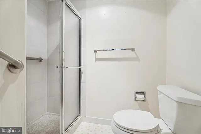 a white toilet sitting next to a bathroom sink