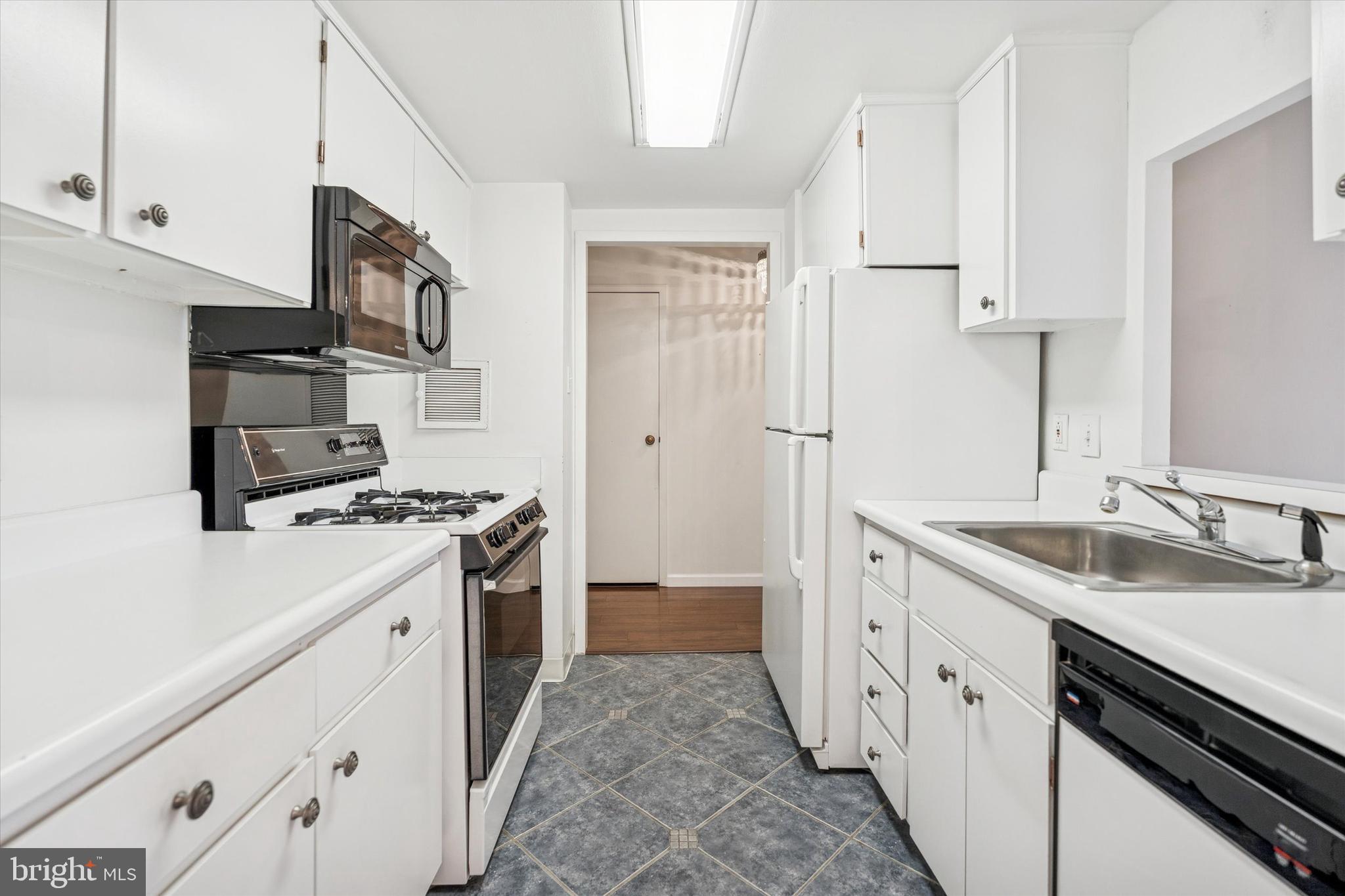 100 West Avenue, Unit 329S Jenkintown, PA 19046 - Photo 2 of 19 a kitchen with stainless steel appliances granite countertop a sink stove and refrigerator