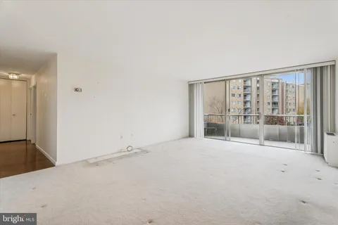 a view of an empty room with a sliding door