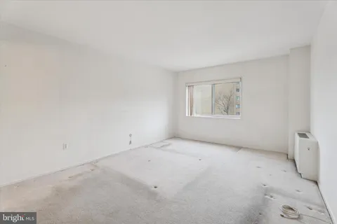 an empty room with windows and closet