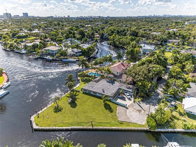 an aerial view of a house with a swimming pool and outdoor seating