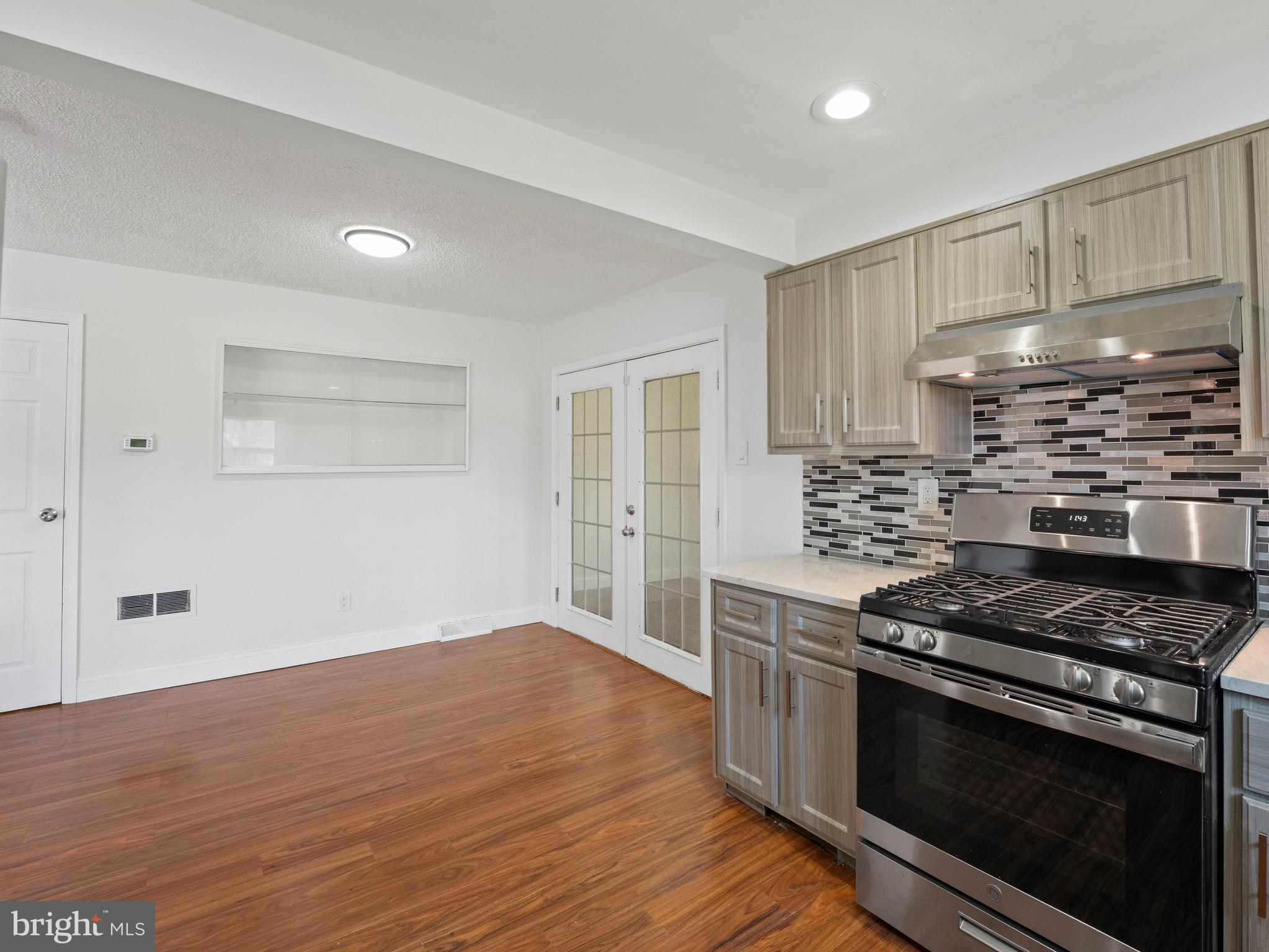 157 West Browning Road Bellmawr, NJ 08031 - Photo 12 of 41 a kitchen with granite countertop a stove and a refrigerator
