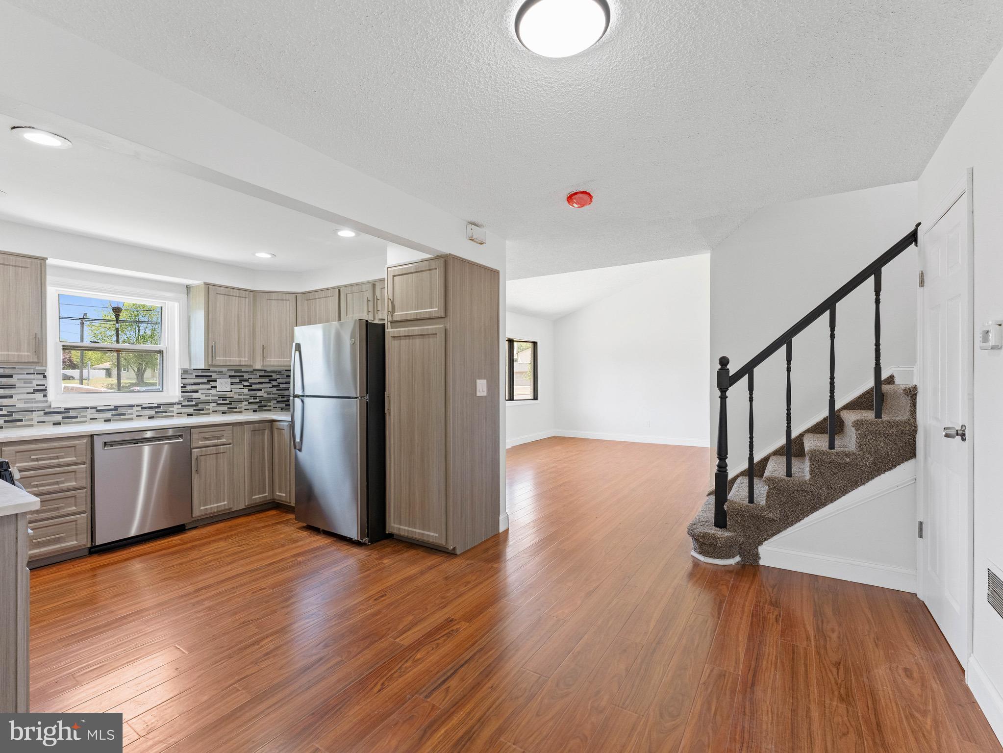 157 West Browning Road Bellmawr, NJ 08031 - Photo 13 of 41 a kitchen with wooden floors and refrigerator