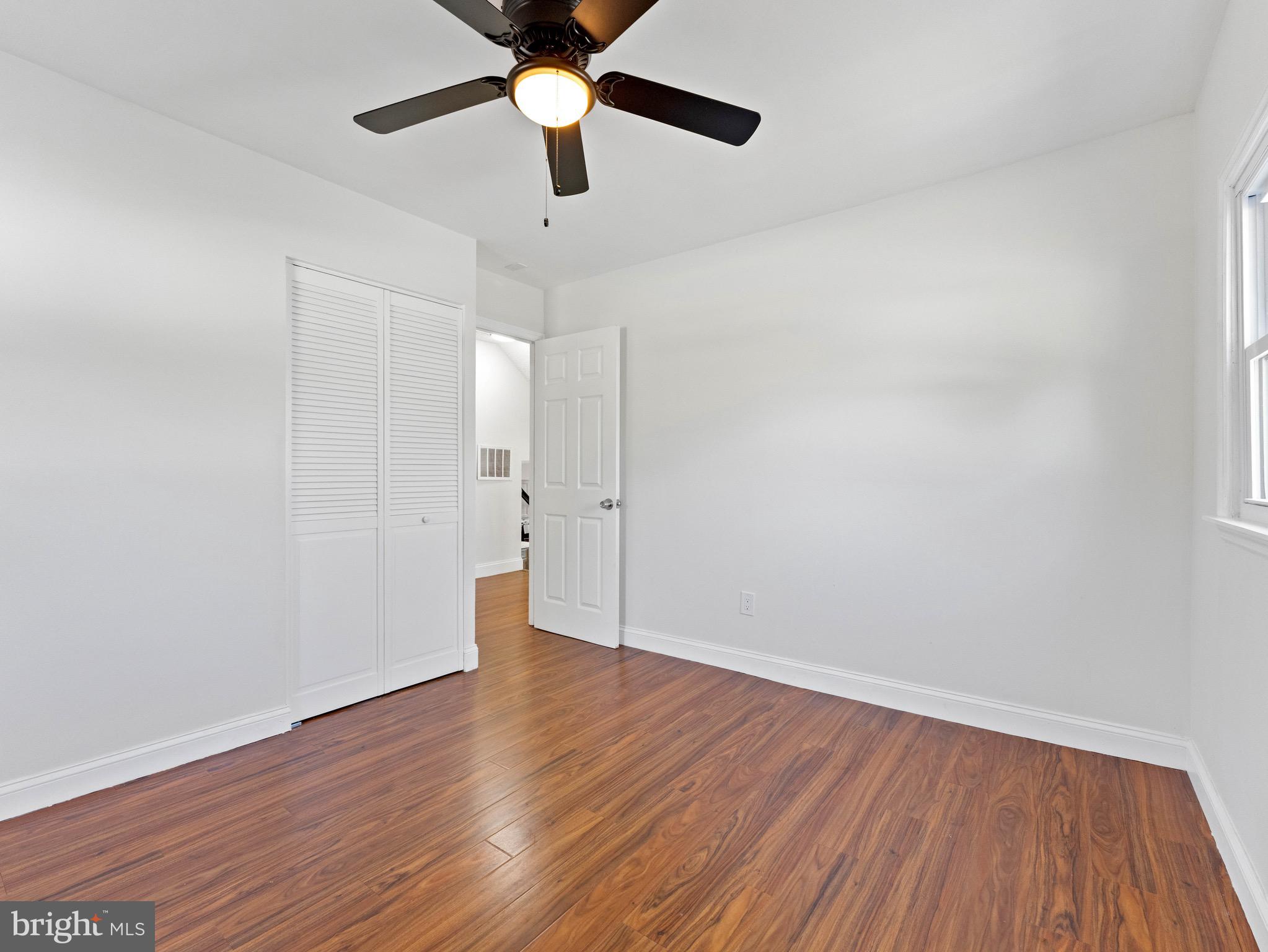 157 West Browning Road Bellmawr, NJ 08031 - Photo 19 of 41 an empty room with wooden floor and a ceiling fan