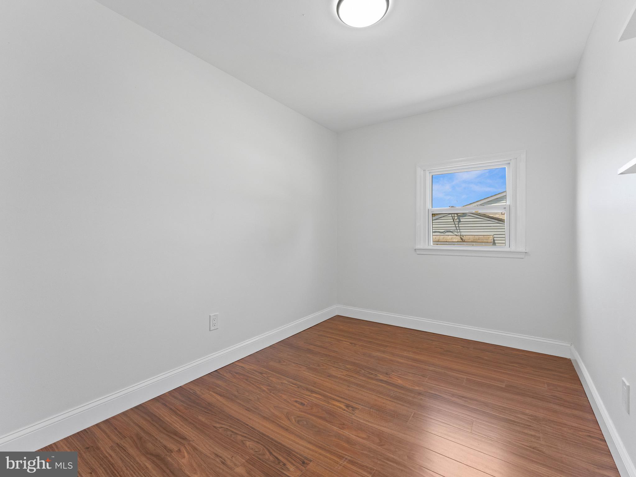 157 West Browning Road Bellmawr, NJ 08031 - Photo 20 of 41 a view of an empty room with wooden floor and a window