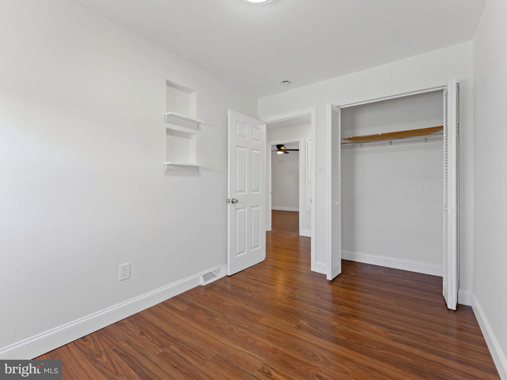 157 West Browning Road Bellmawr, NJ 08031 - Photo 21 of 41 a view of an empty room with wooden floor and closet