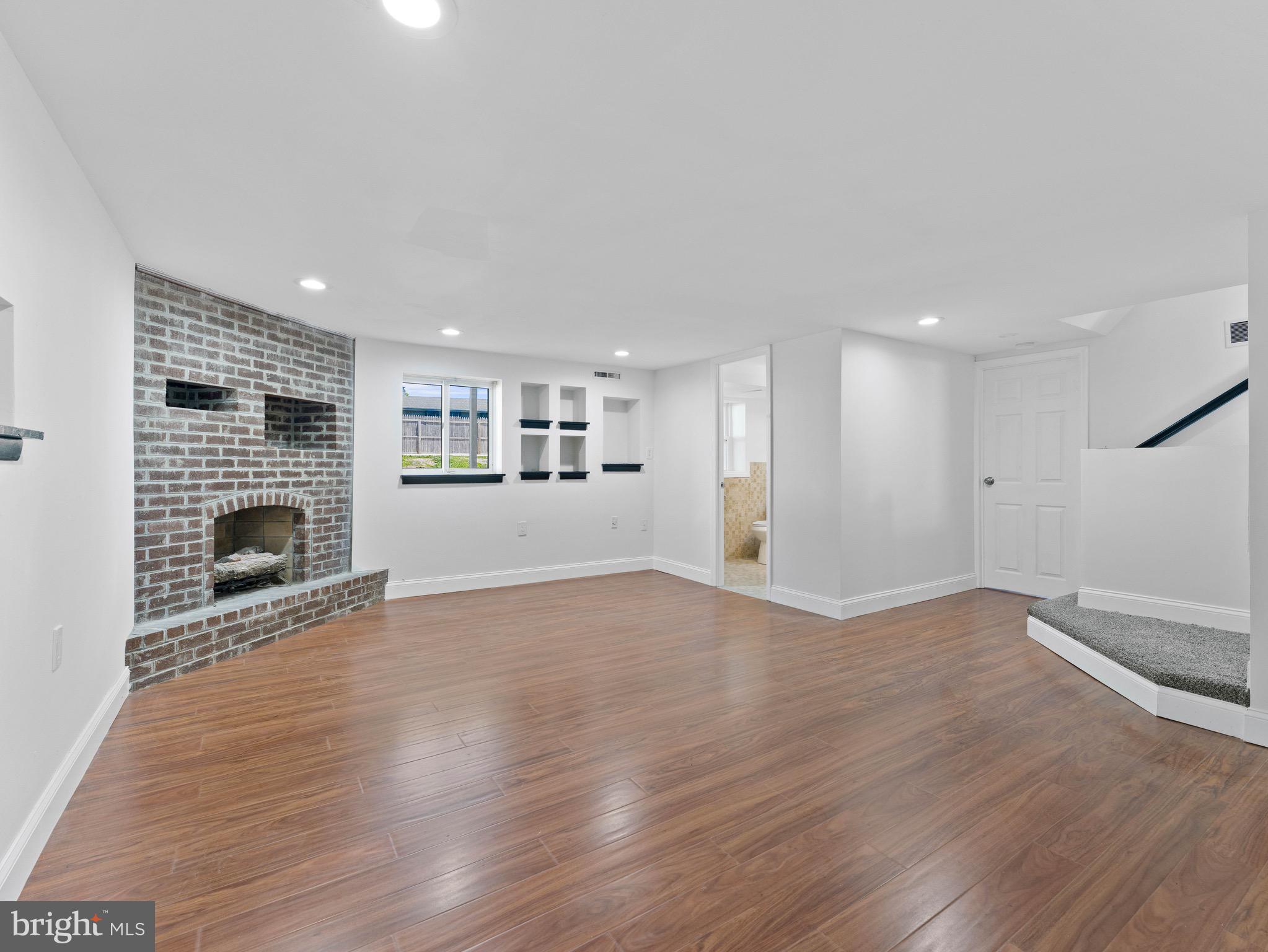 157 West Browning Road Bellmawr, NJ 08031 - Photo 25 of 41 a view of a livingroom with wooden floor and a fireplace