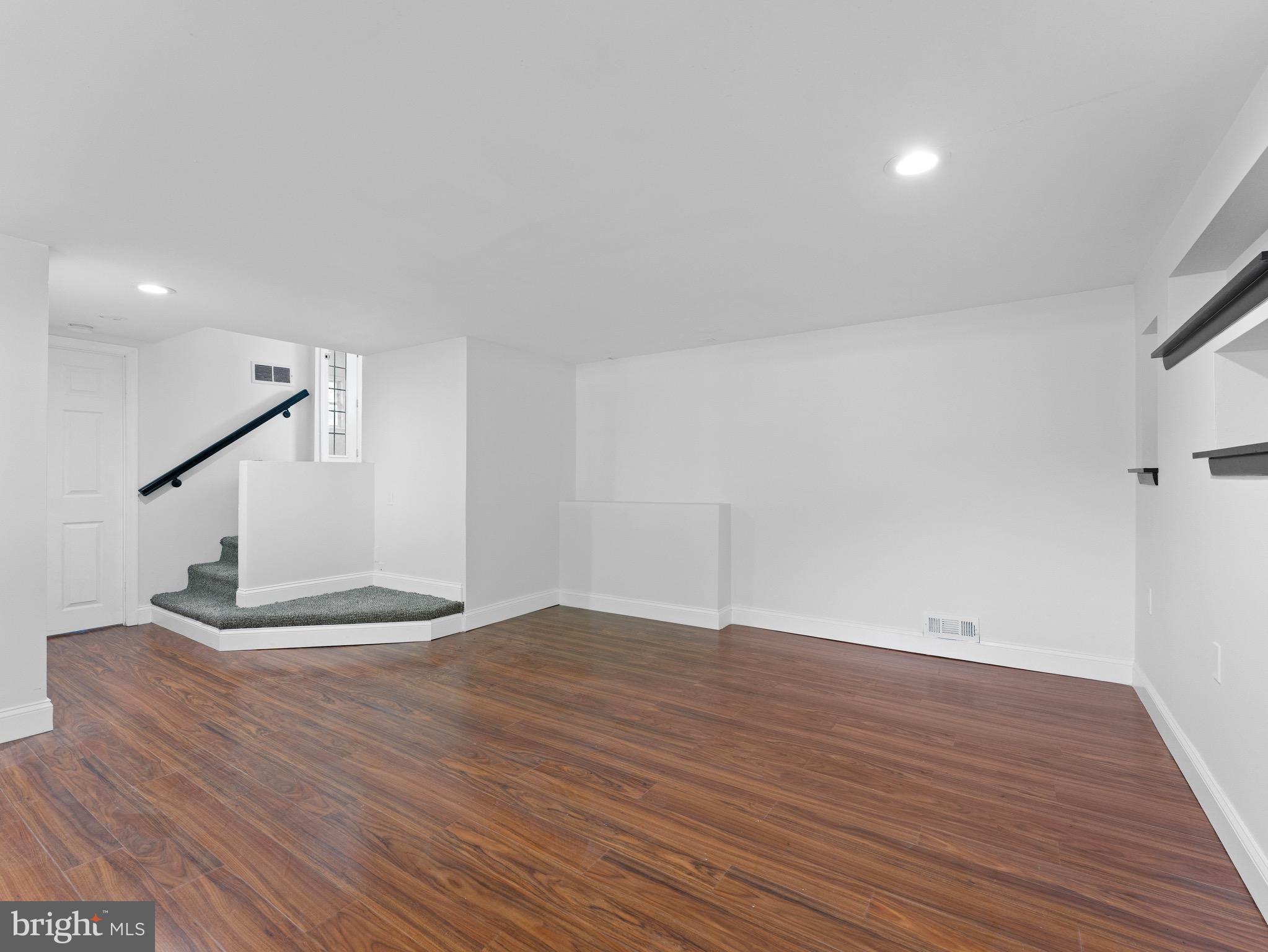 157 West Browning Road Bellmawr, NJ 08031 - Photo 26 of 41 a view of an empty room with wooden floor and stairs