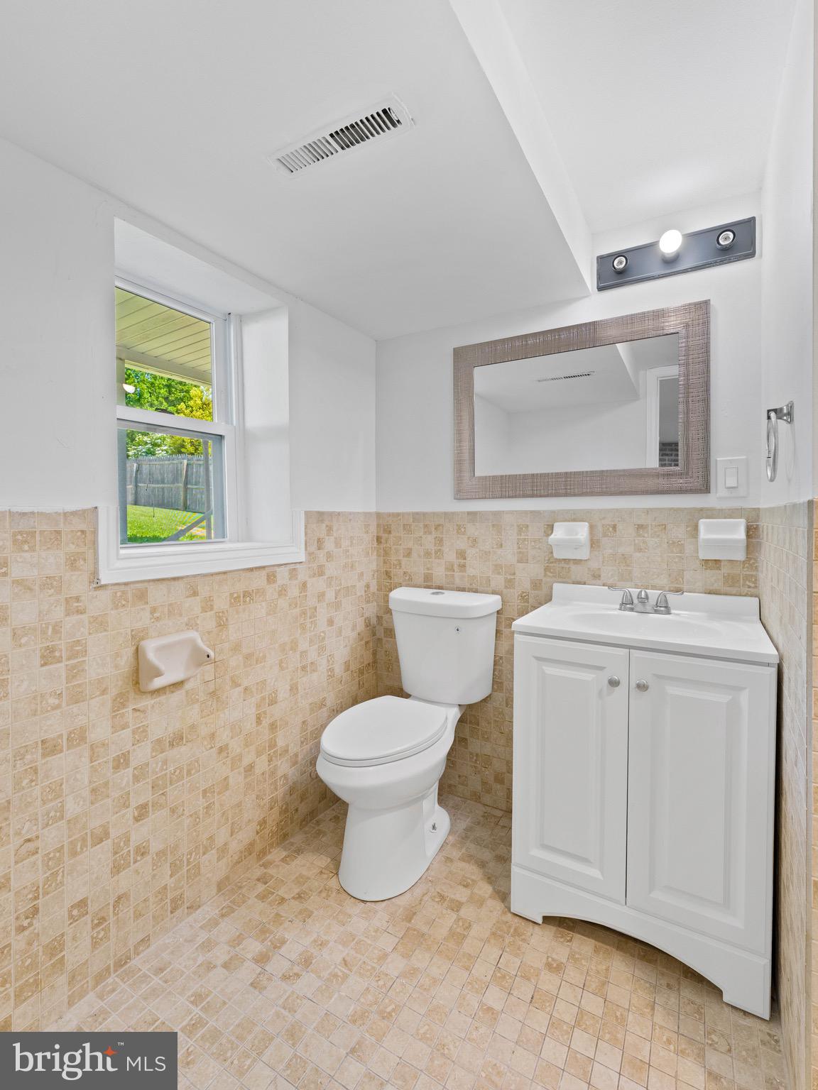 157 West Browning Road Bellmawr, NJ 08031 - Photo 27 of 41 a bathroom with a toilet sink vanity and mirror