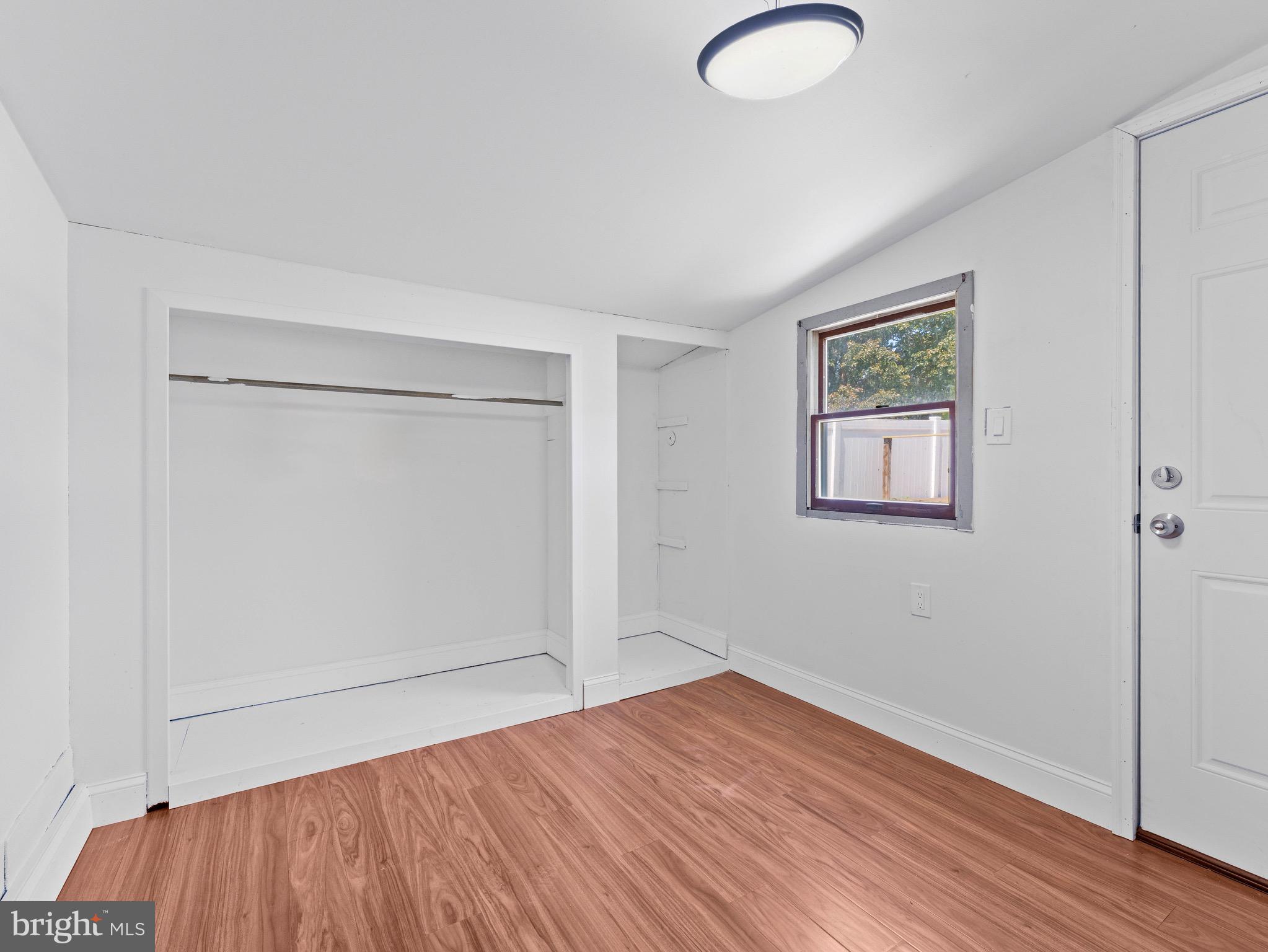 157 West Browning Road Bellmawr, NJ 08031 - Photo 36 of 41 an empty room with wooden floor and windows