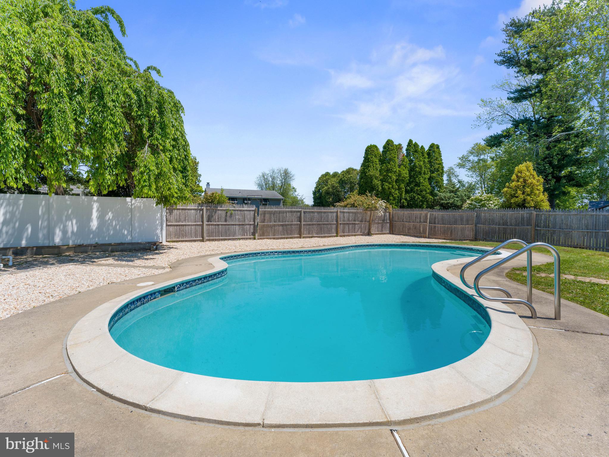 157 West Browning Road Bellmawr, NJ 08031 - Photo 37 of 41 a view of a swimming pool with a yard and wooden fence