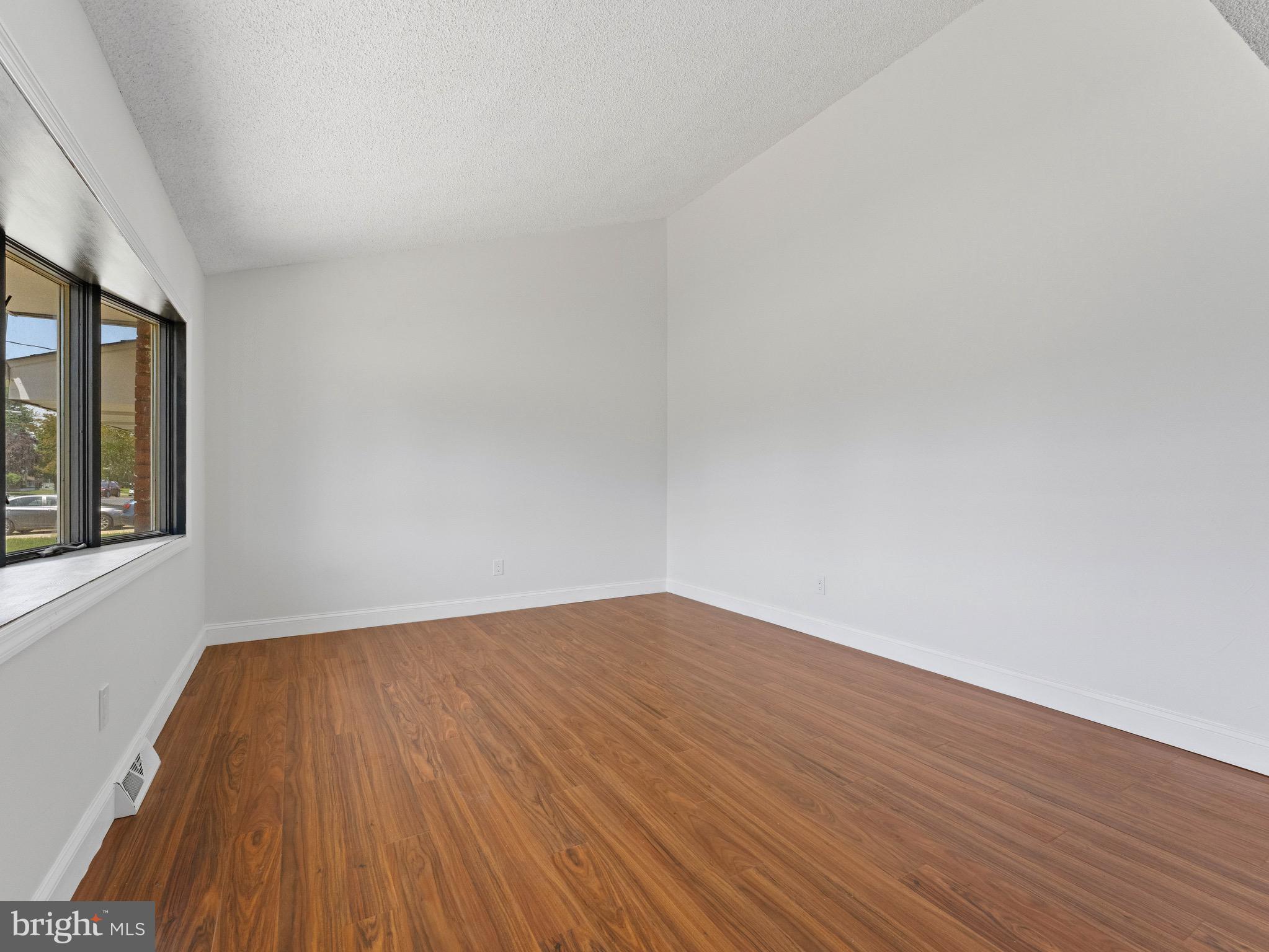 157 West Browning Road Bellmawr, NJ 08031 - Photo 5 of 41 a view of an empty room with wooden floor and a window