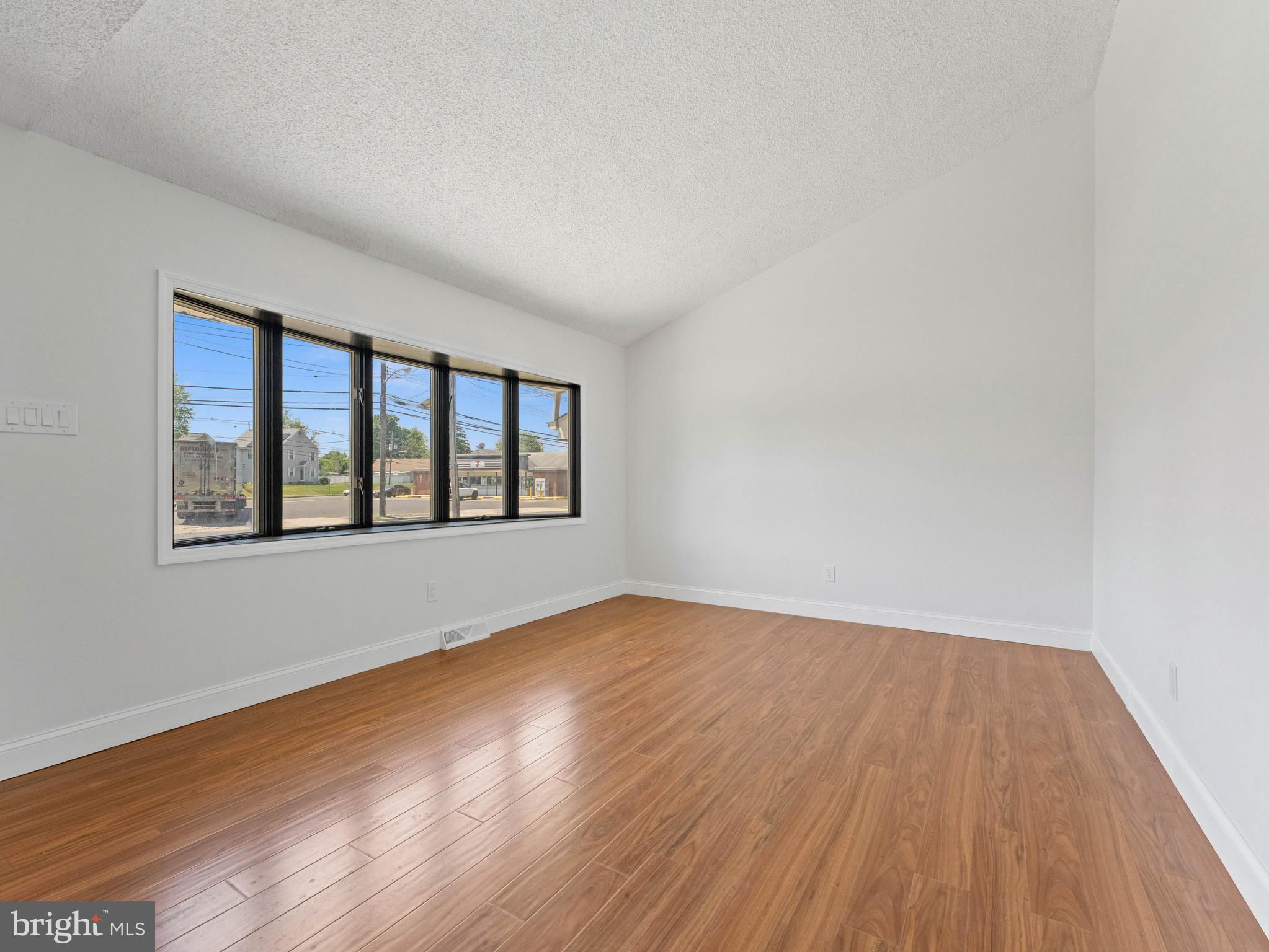 157 West Browning Road Bellmawr, NJ 08031 - Photo 6 of 41 an empty room with wooden floor and windows
