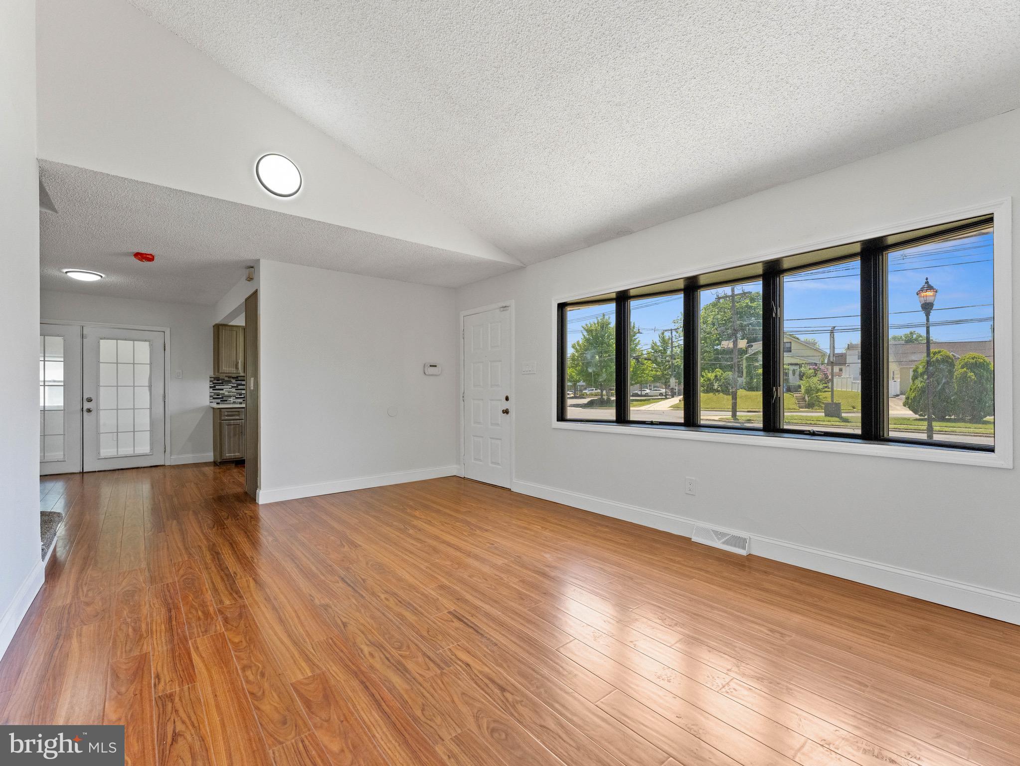 157 West Browning Road Bellmawr, NJ 08031 - Photo 7 of 41 a view of an empty room with wooden floor and a window