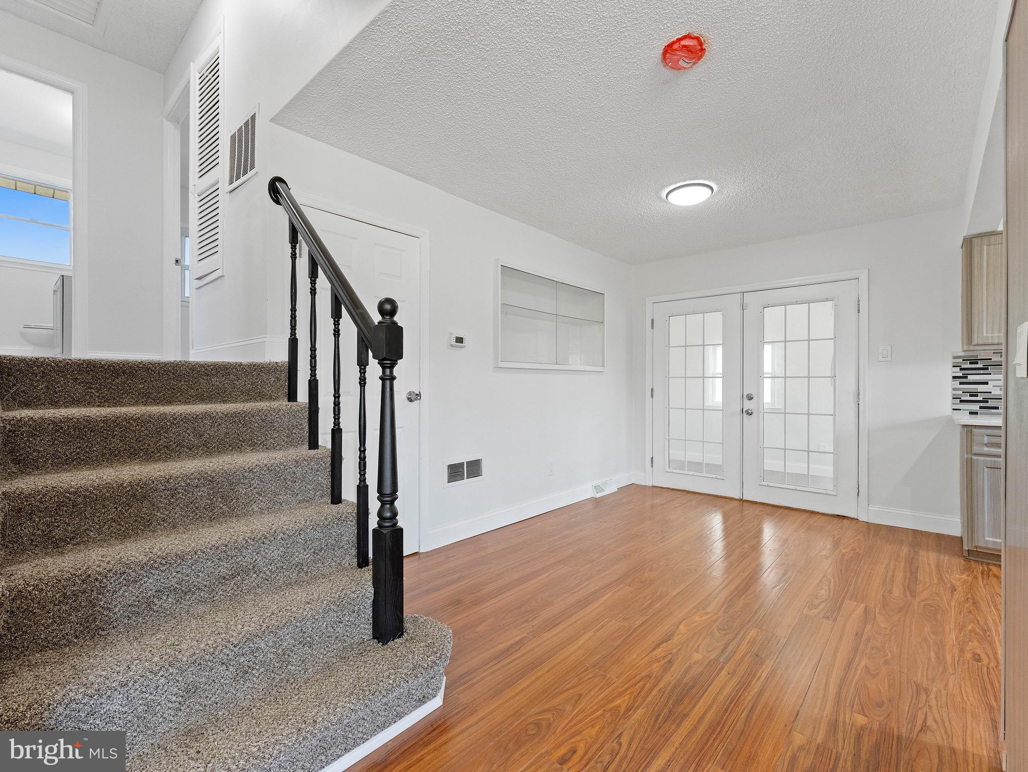 157 West Browning Road Bellmawr, NJ 08031 - Photo 8 of 41 a view of an empty room with wooden floor and stairs