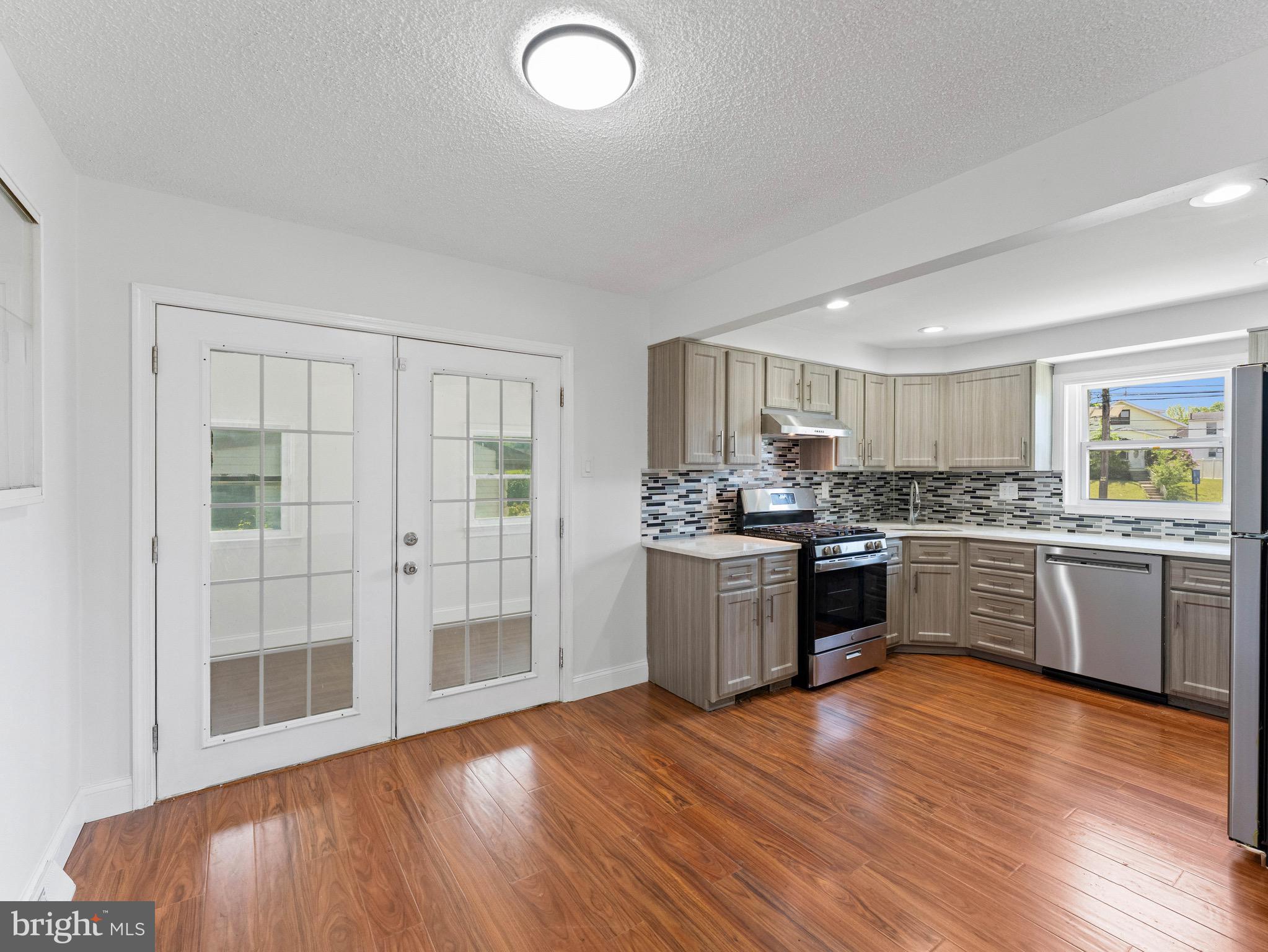 157 West Browning Road Bellmawr, NJ 08031 - Photo 9 of 41 a kitchen with a refrigerator and a stove top oven